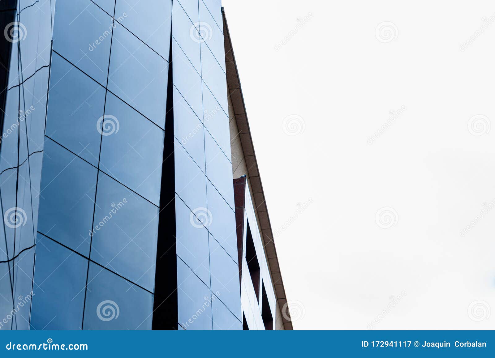 glazed building with reflections where the working middle class aspires to buy residences as executives