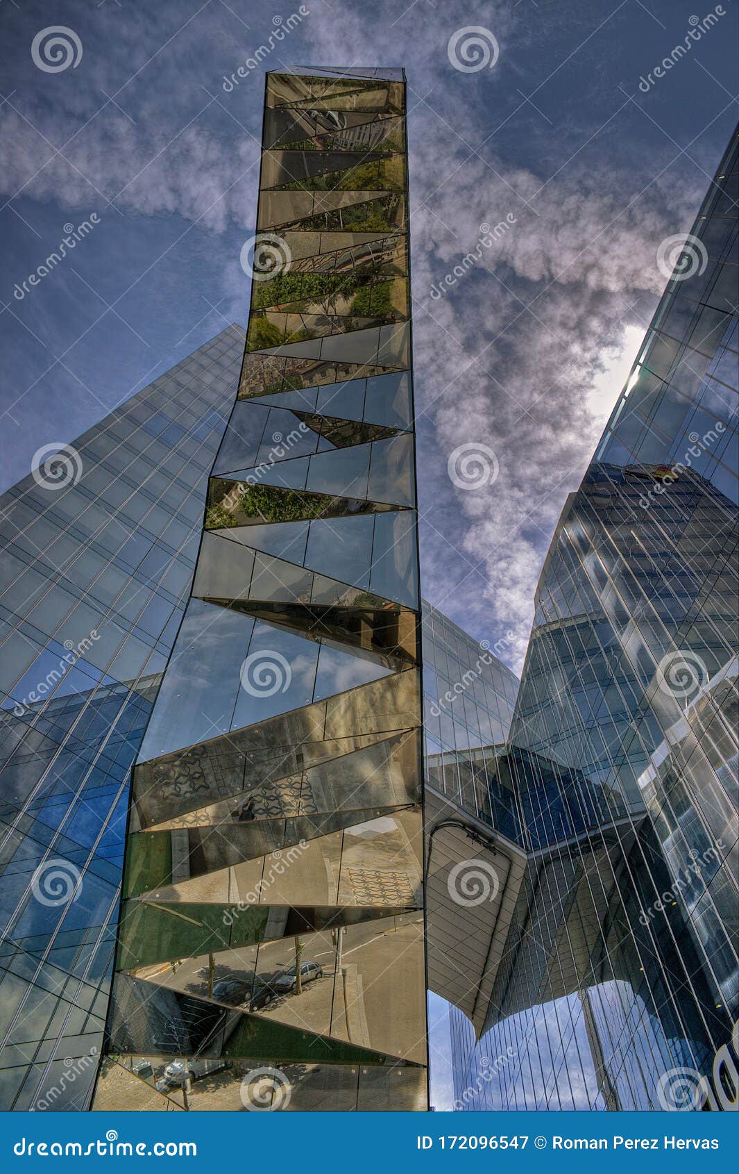 glazed office building with reflections of other buildings