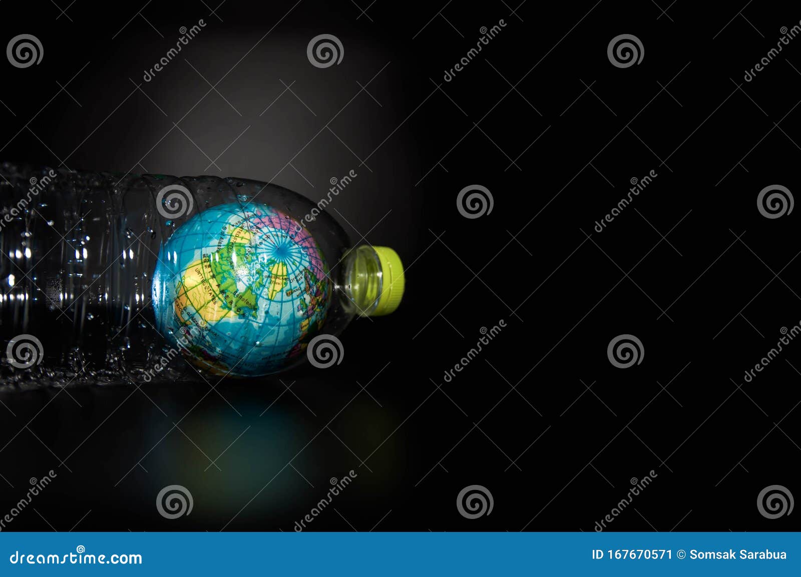 A Globe In A Plastic Bottle On Black Background, Which Is Concept Of
