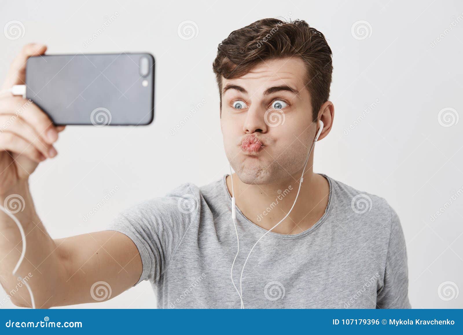 Gloomy Caucasian Male Frowns Face, Holding Smart Phone in His Hand ...