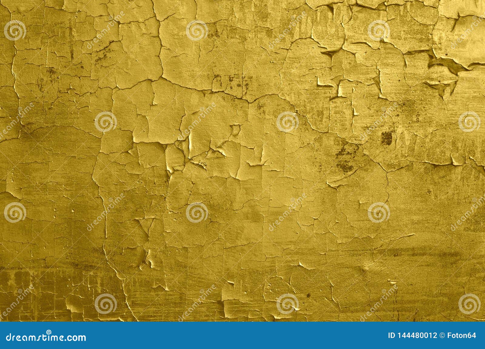 texture of old wall with a cracked golden paint. Stock Photo