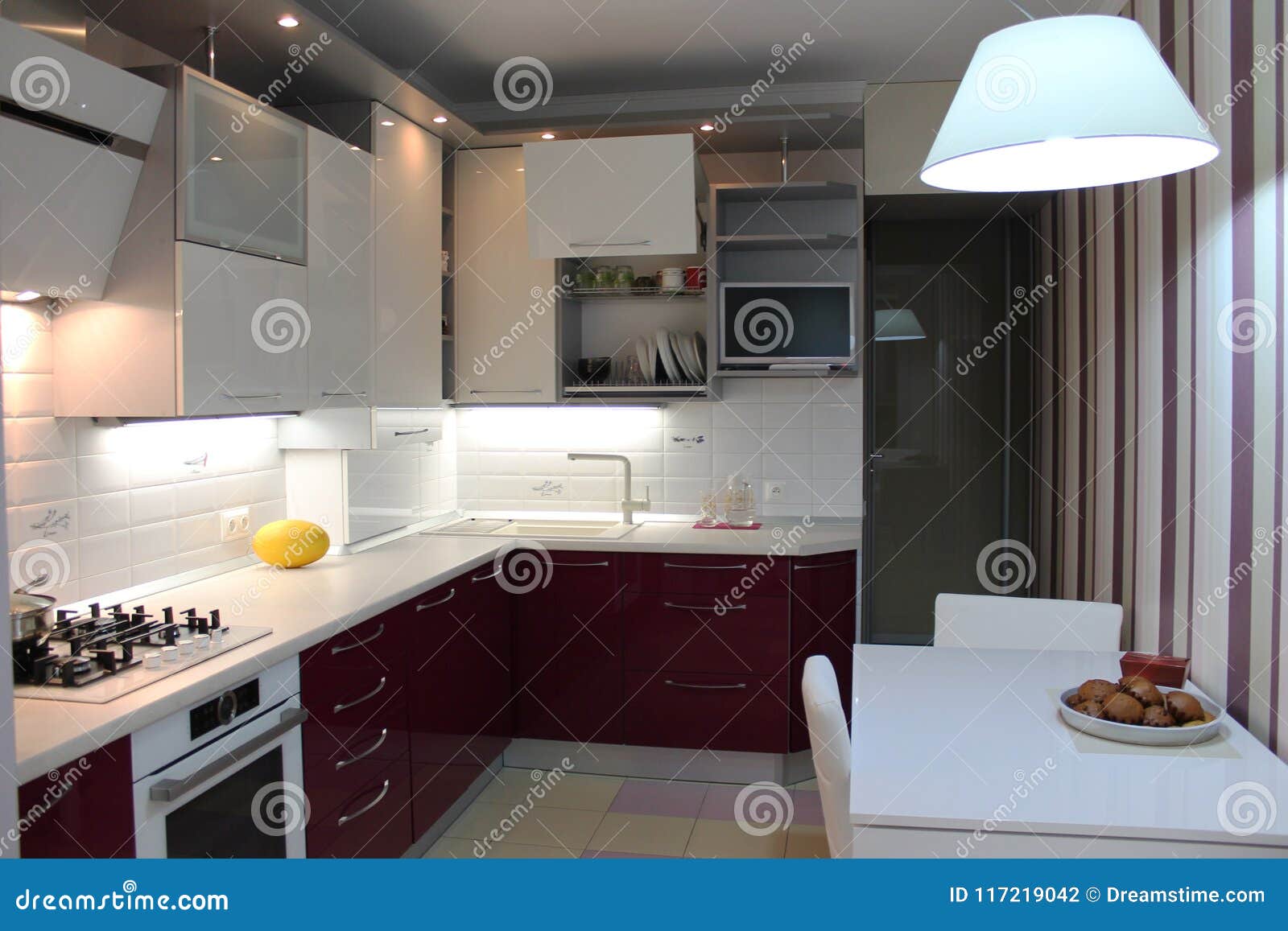 Glossy Modern Kitchen With White Top And Cherry Bottom Stock Photo