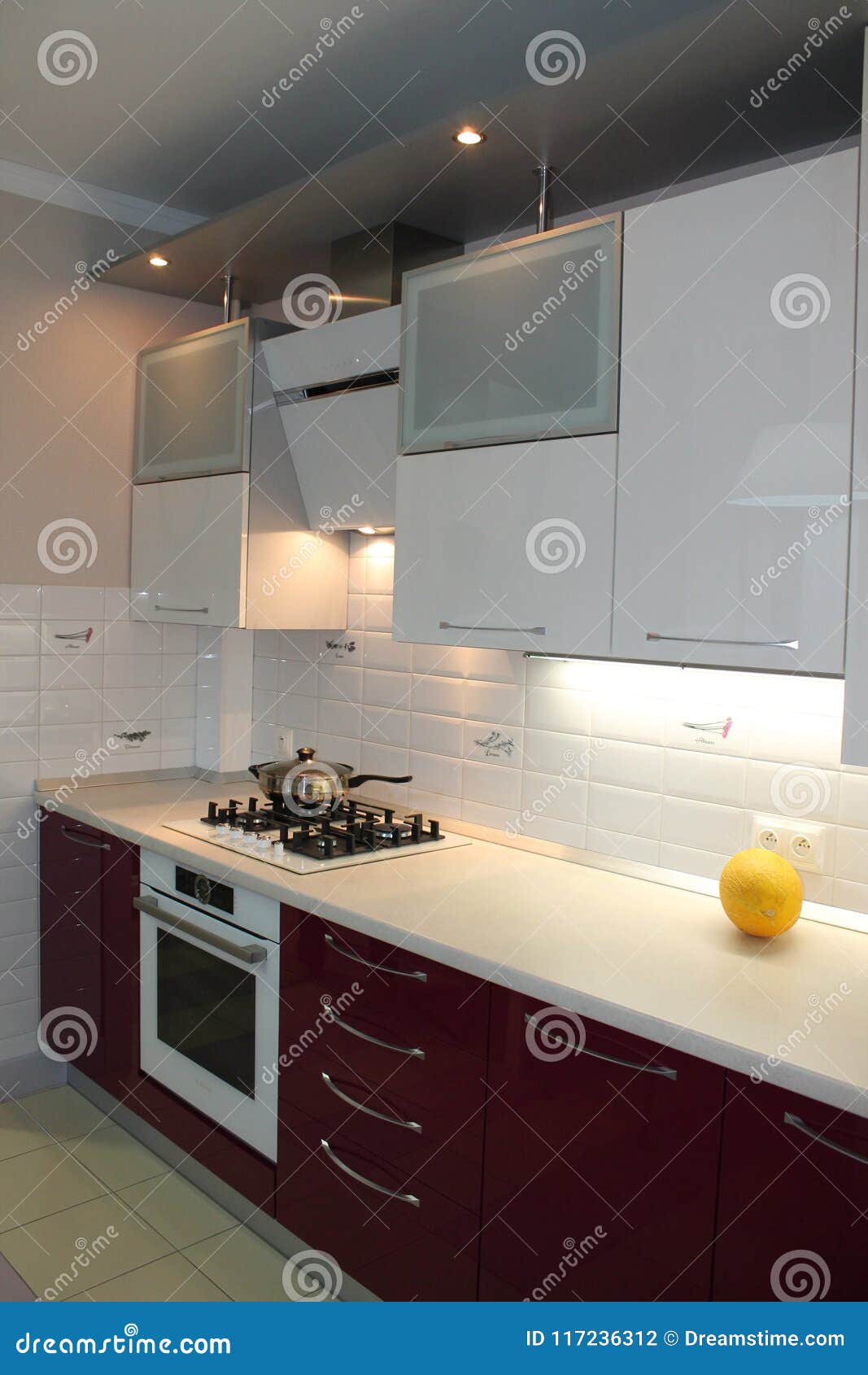 Glossy Modern Kitchen With White Top And Cherry Bottom Stock Photo