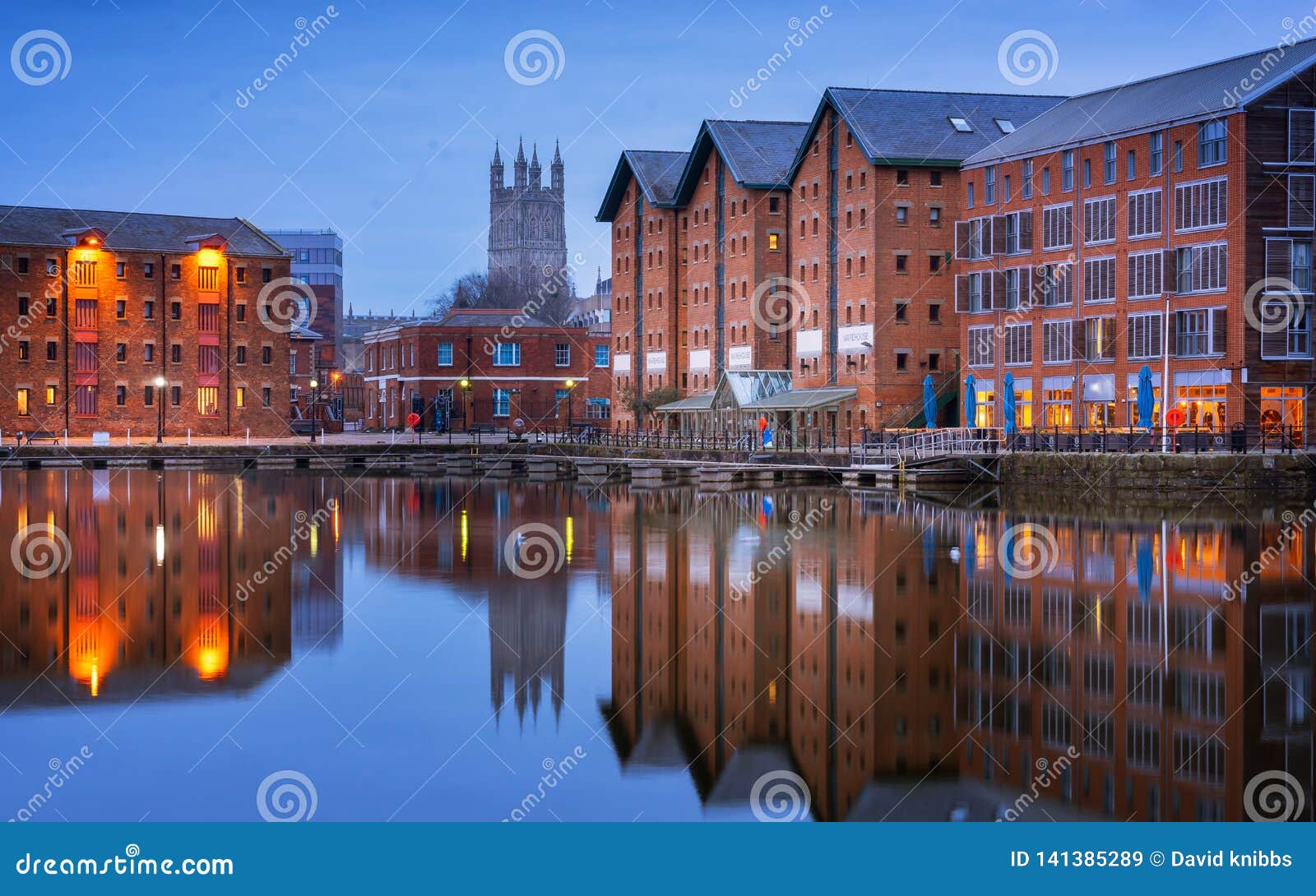 gloucester docks and cathedral reflected in the quay on sharpness at twilight
