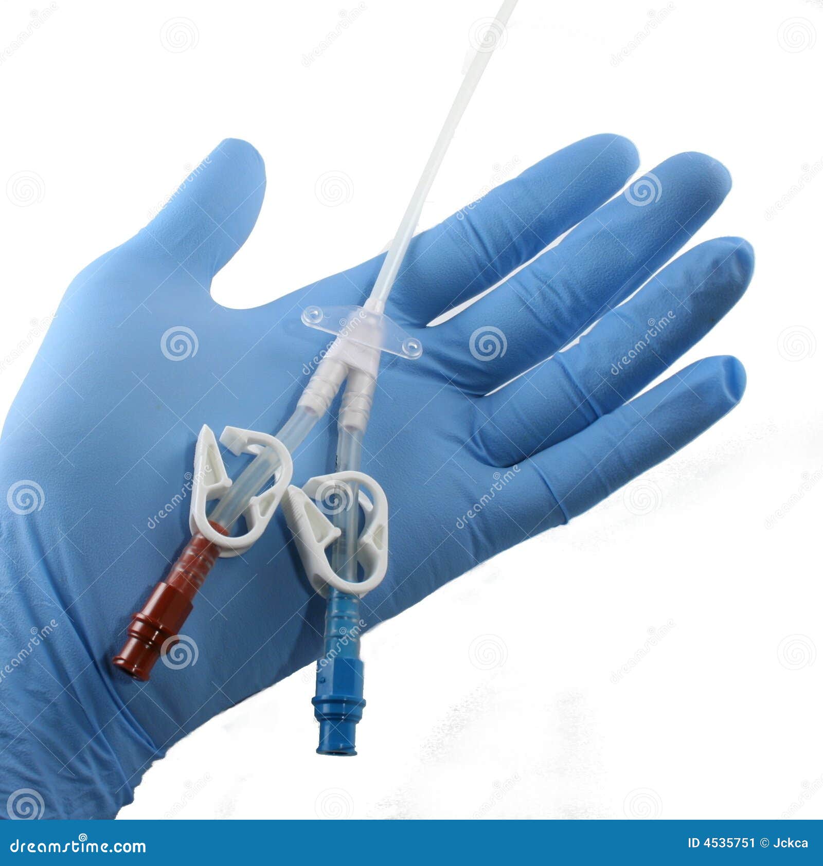 gloved hand holding a catheter