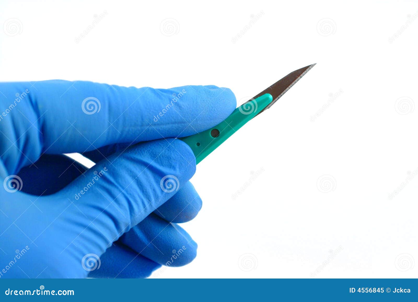 gloved hand holding scalpel