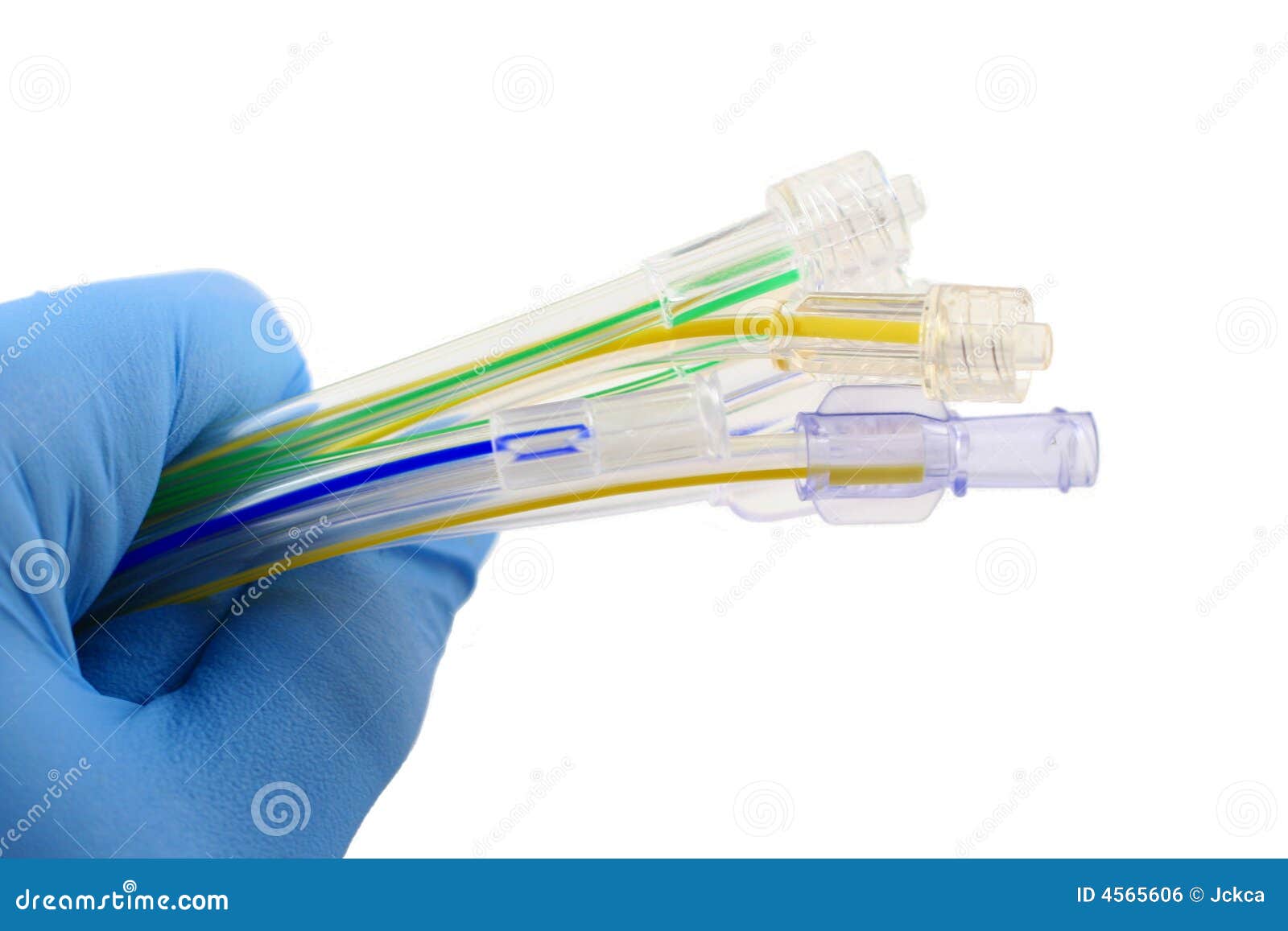 gloved hand holding surgical tubing