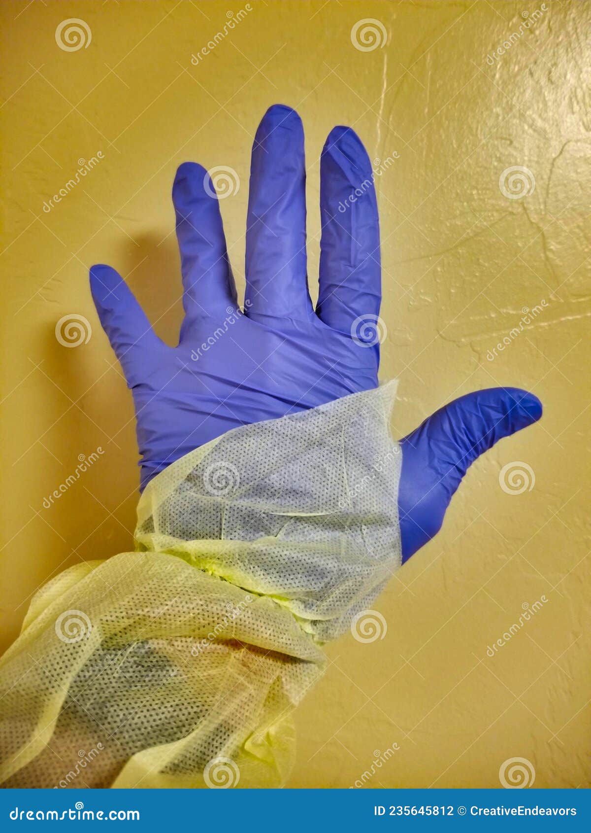 covid-19 isolation unit - gloved hand, isolation gown