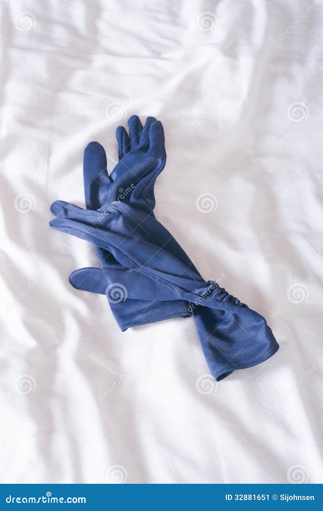 Gloves on bed stock image. Image of blue, classy, sheet 32881651