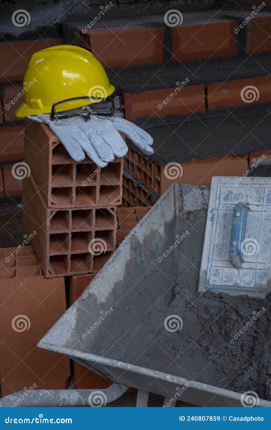 gloves, helmet and goggles on pile of bricks