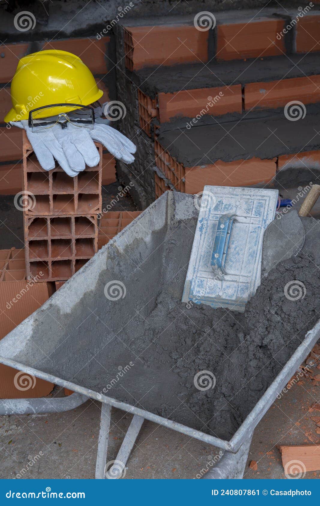 gloves, helmet and goggles on pile of bricks