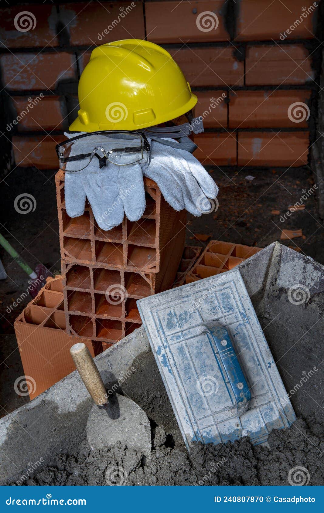 gloves, helmet and goggles on pile of bricks