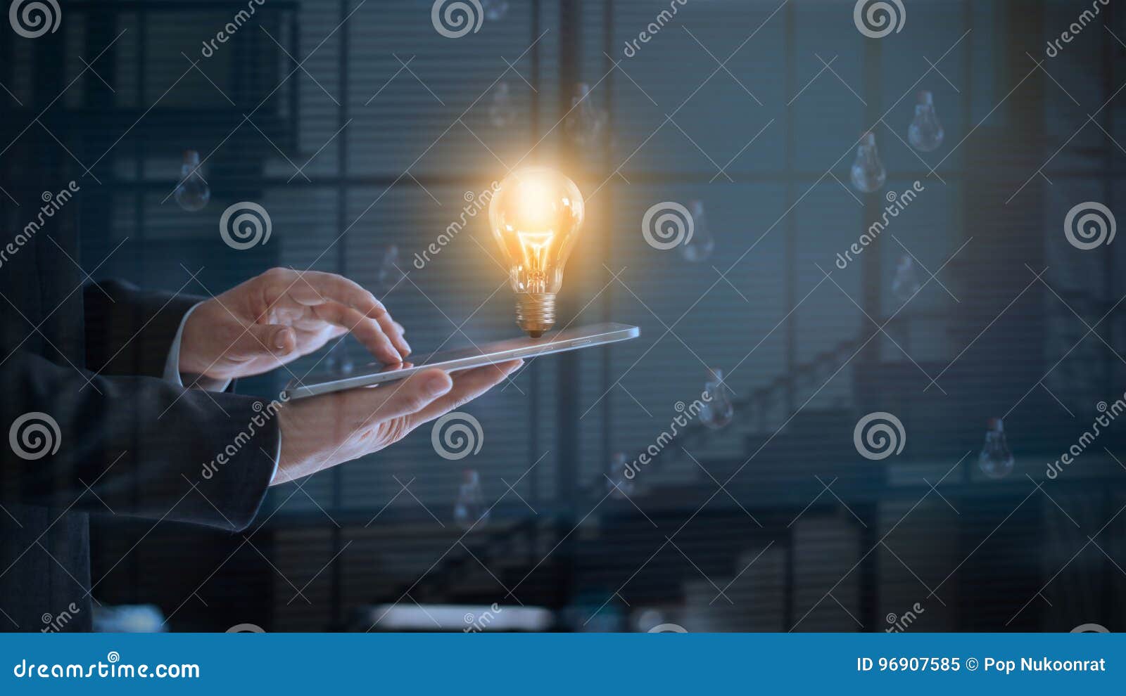 glowing light bulb over labtop of businessman among others