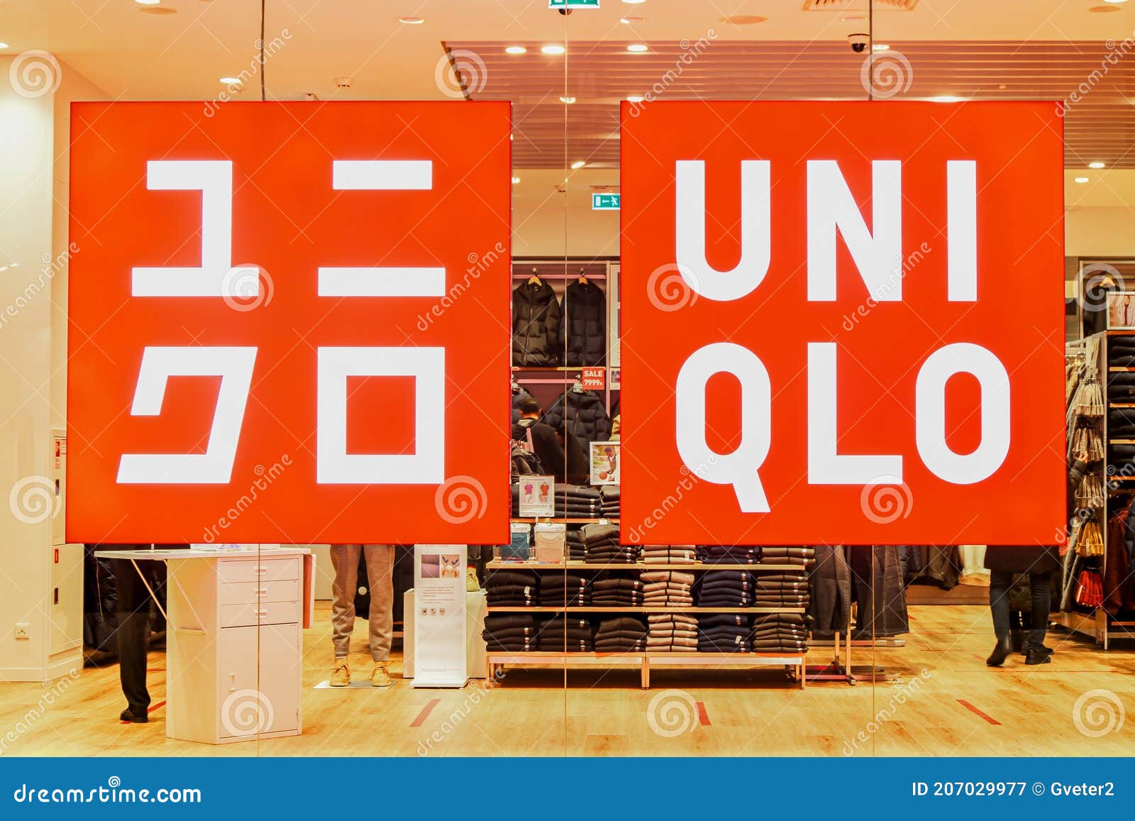 Glowing Sign with Brand and Logo of UNIQLO Clothing Store on Glass ...
