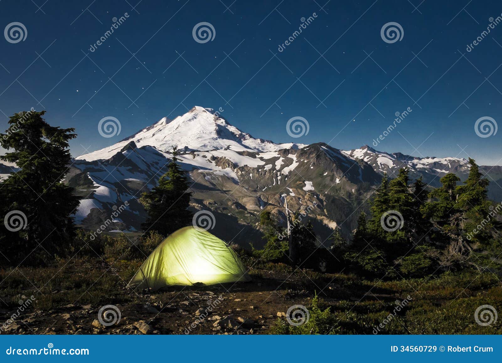 Glowing Tent at Night Beneath Mount Baker, Washington State Stock Image