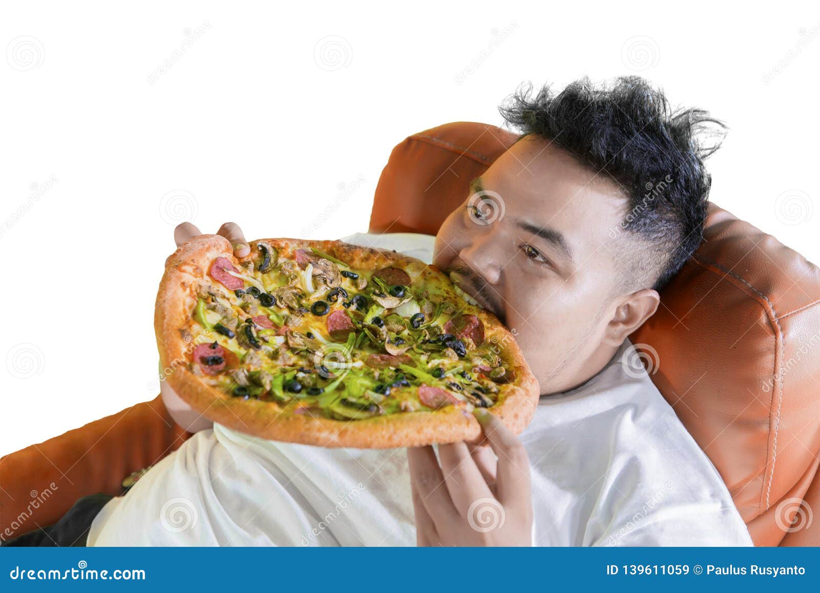 gluttony fat man eating big pizza on the sofa
