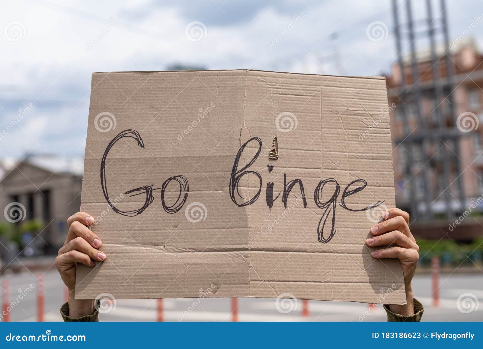 go binge. cheeky rebellious text in a sign. hand holding banner