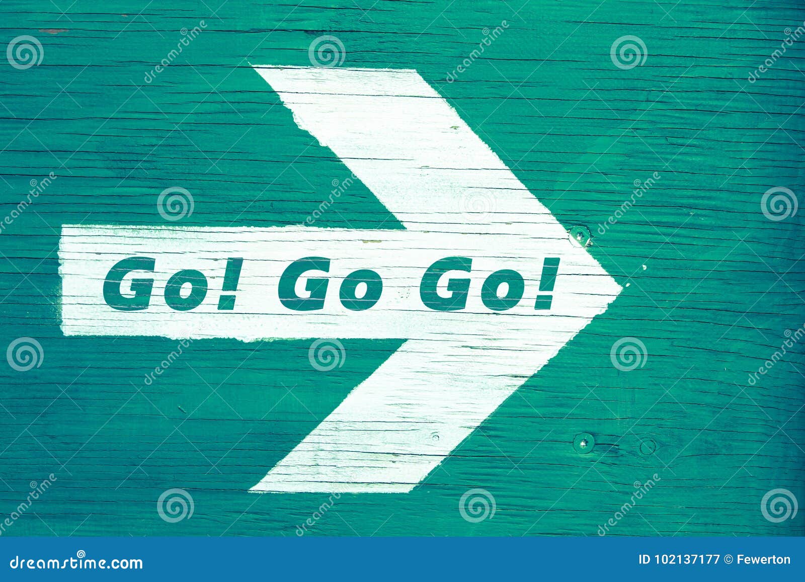`go! go go!` text written on a white directional arrow