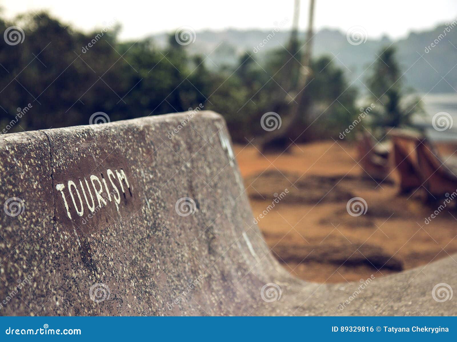 Goa, India. Bench with the Word Tourism. Stock Photo Image of sand