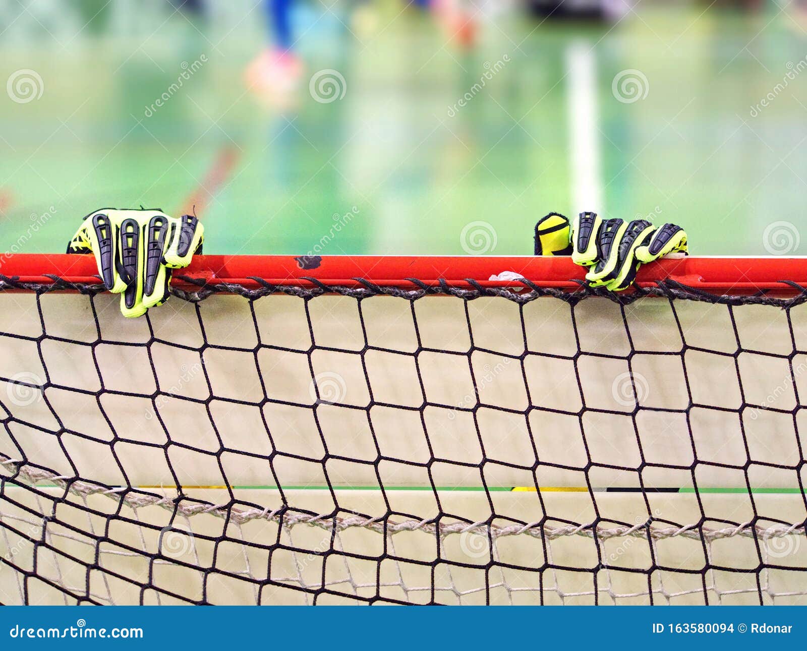 Goalkeeper Gloves are on the Beam of Football Goal Gate. Exact Sports