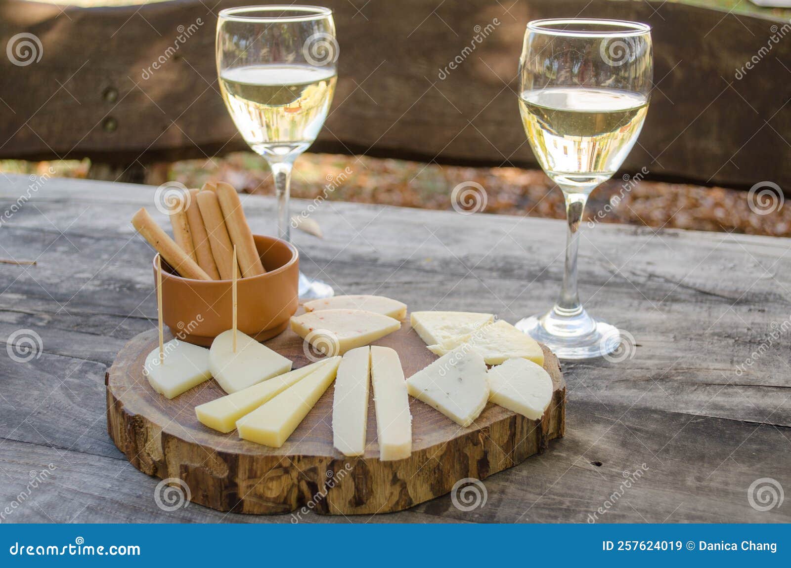 Goat Cheese and White Wine Sampler Served on a Wooden Board Stock Image
