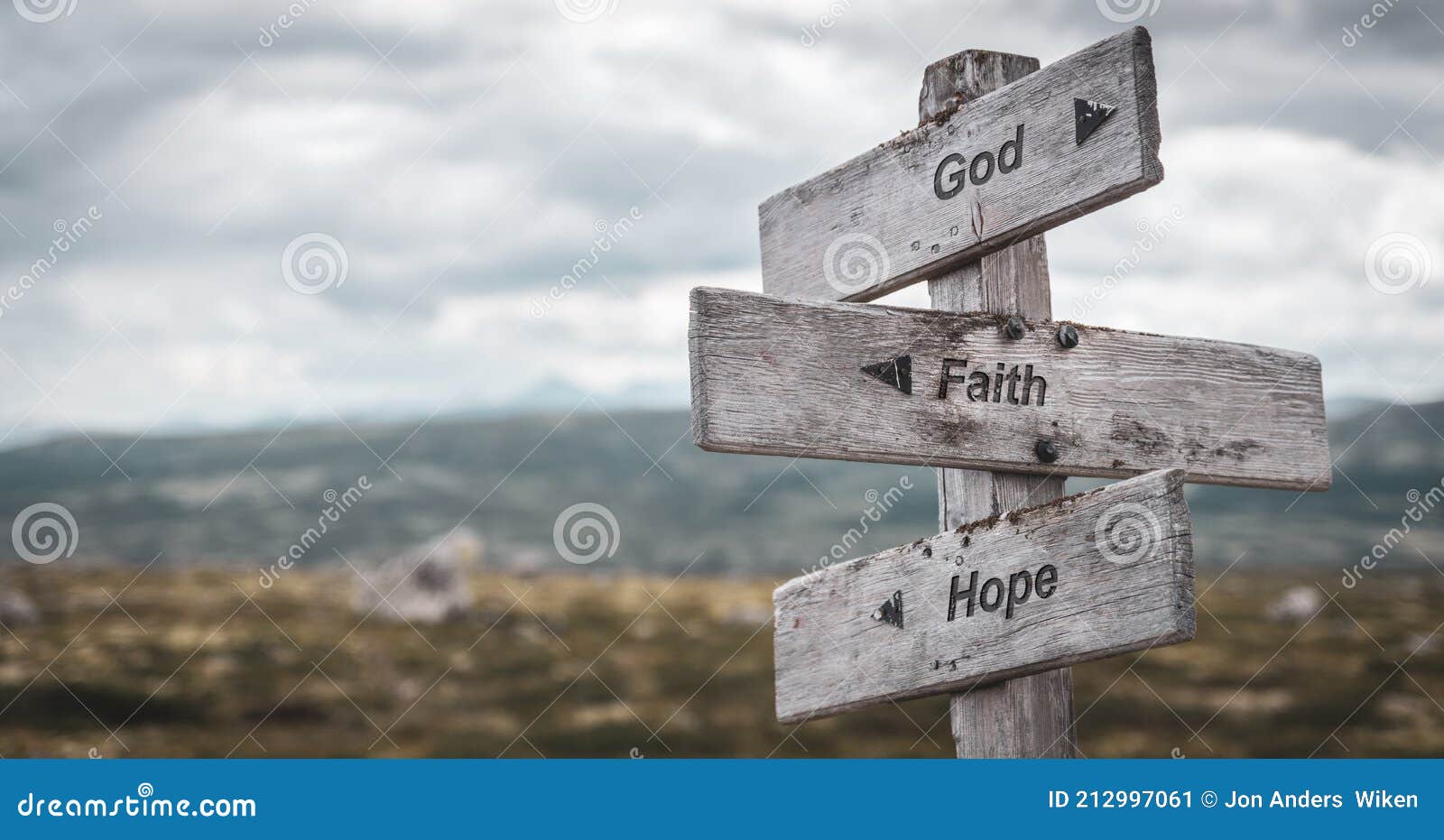god faith hope text engraved on wooden signpost outdoors in nature.