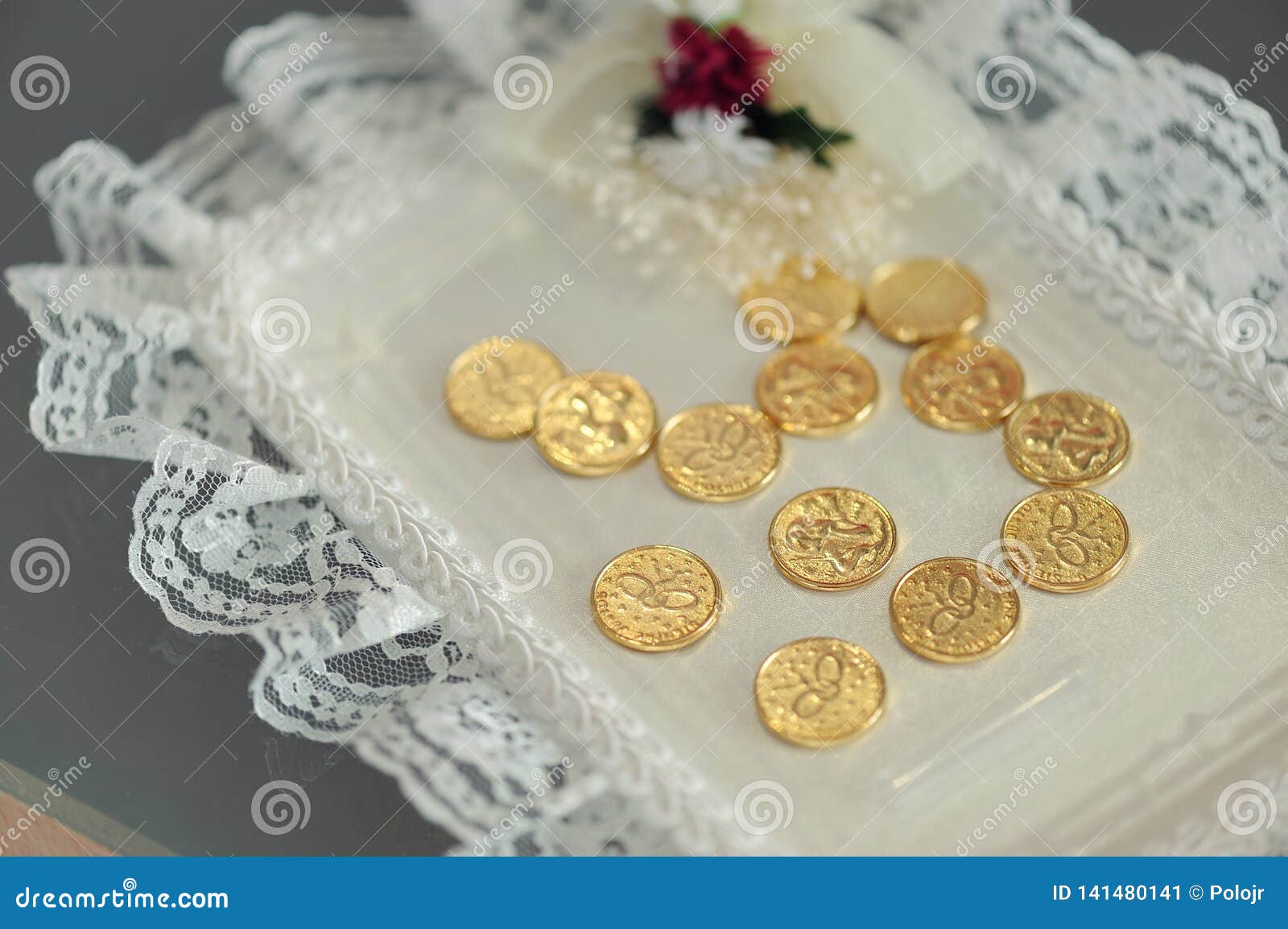 gold coins on lace mat