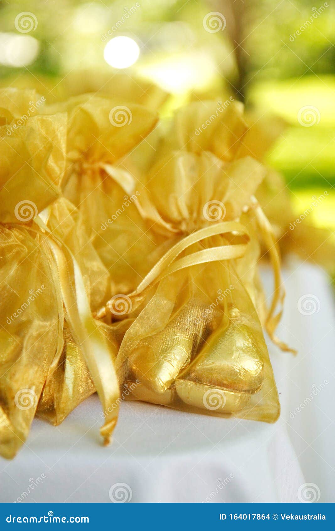 Gold Coloured Chocolate Gift Bags on a Table Setting Stock Photo