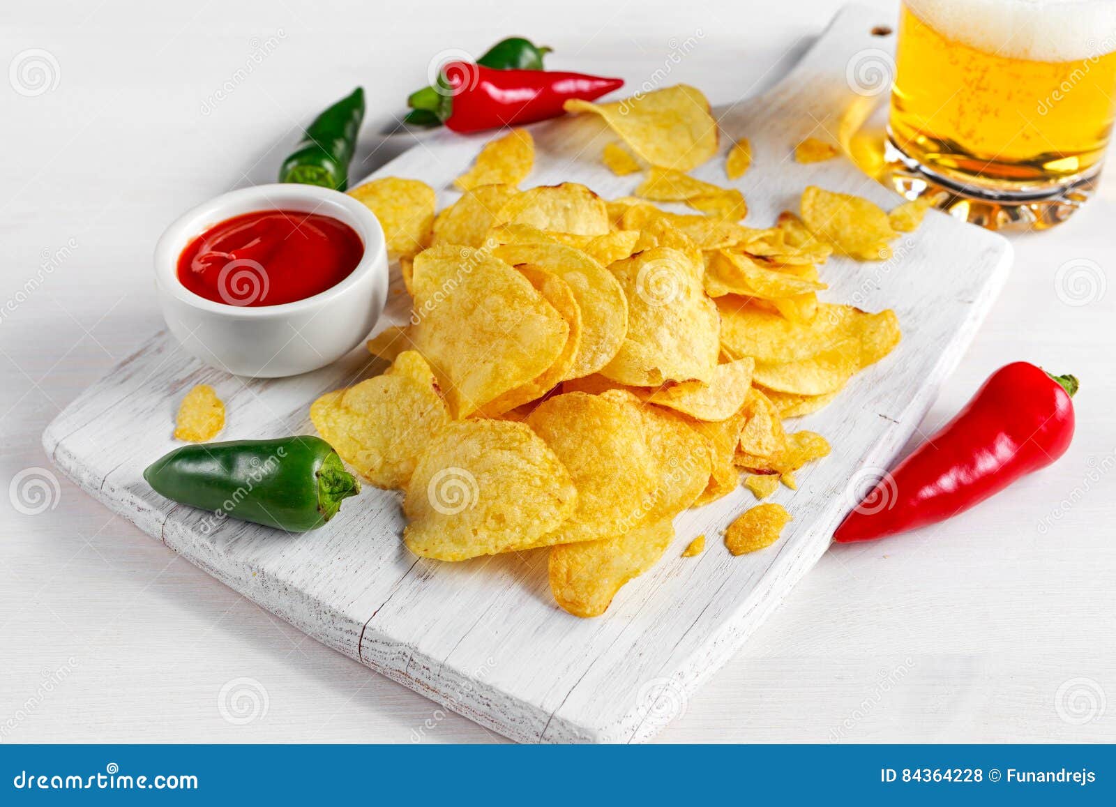 Gold And Crispy Potato Chips With Hot Sauce, Beer On White Board, Background. Stock Photo