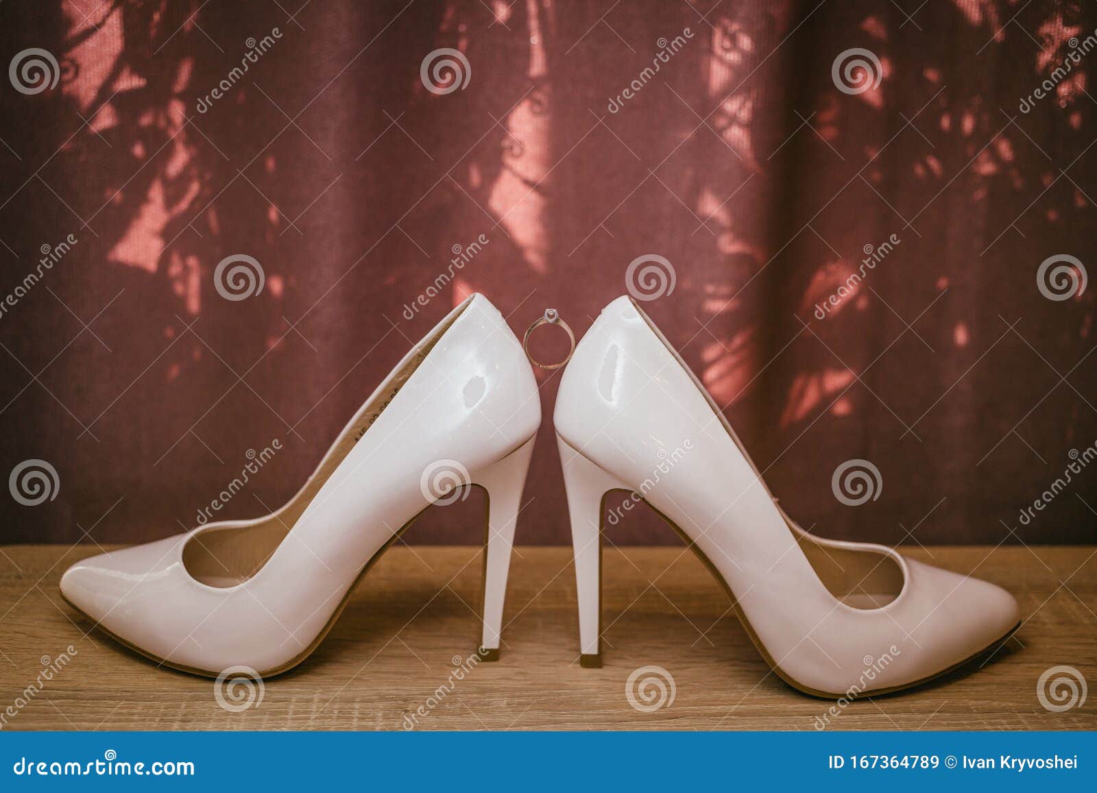 Gold Diamond Ring between Pair of White High Heel Shoes. Wedding ...