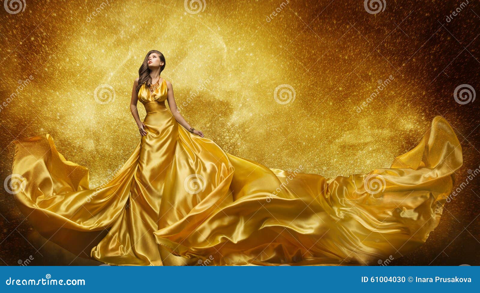 gold fashion model dress, woman golden silk gown flowing fabric