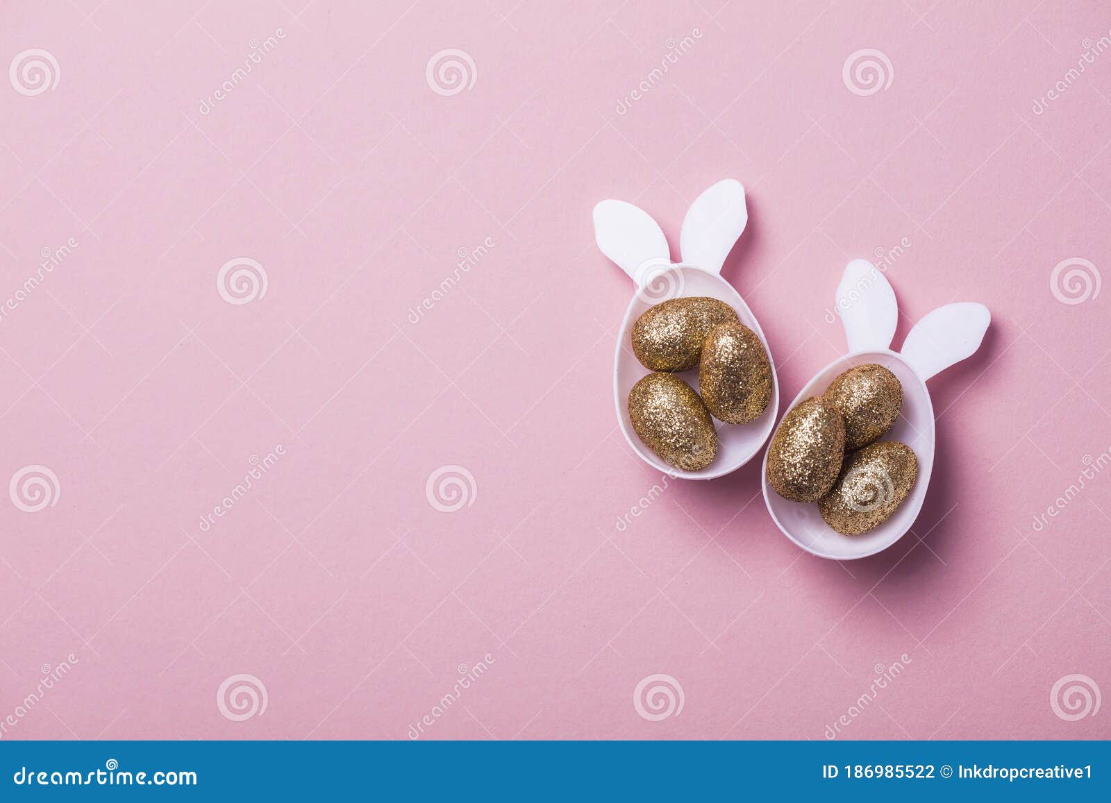 Gold Glitter Eggs in a White Easter Bunny Egg Shape with Ears Stock