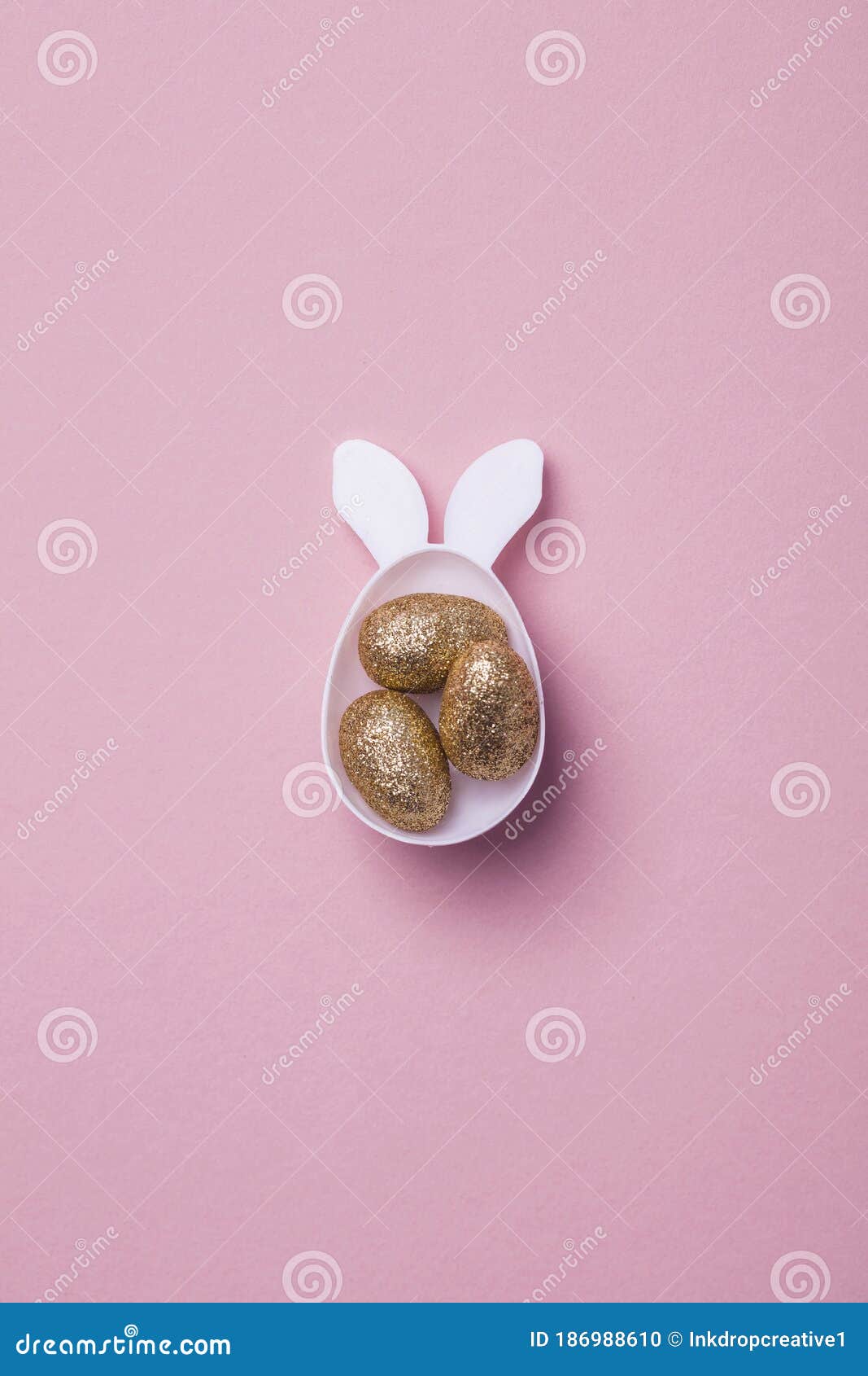 Gold Glitter Eggs in a White Easter Bunny Egg Shape with Ears Stock