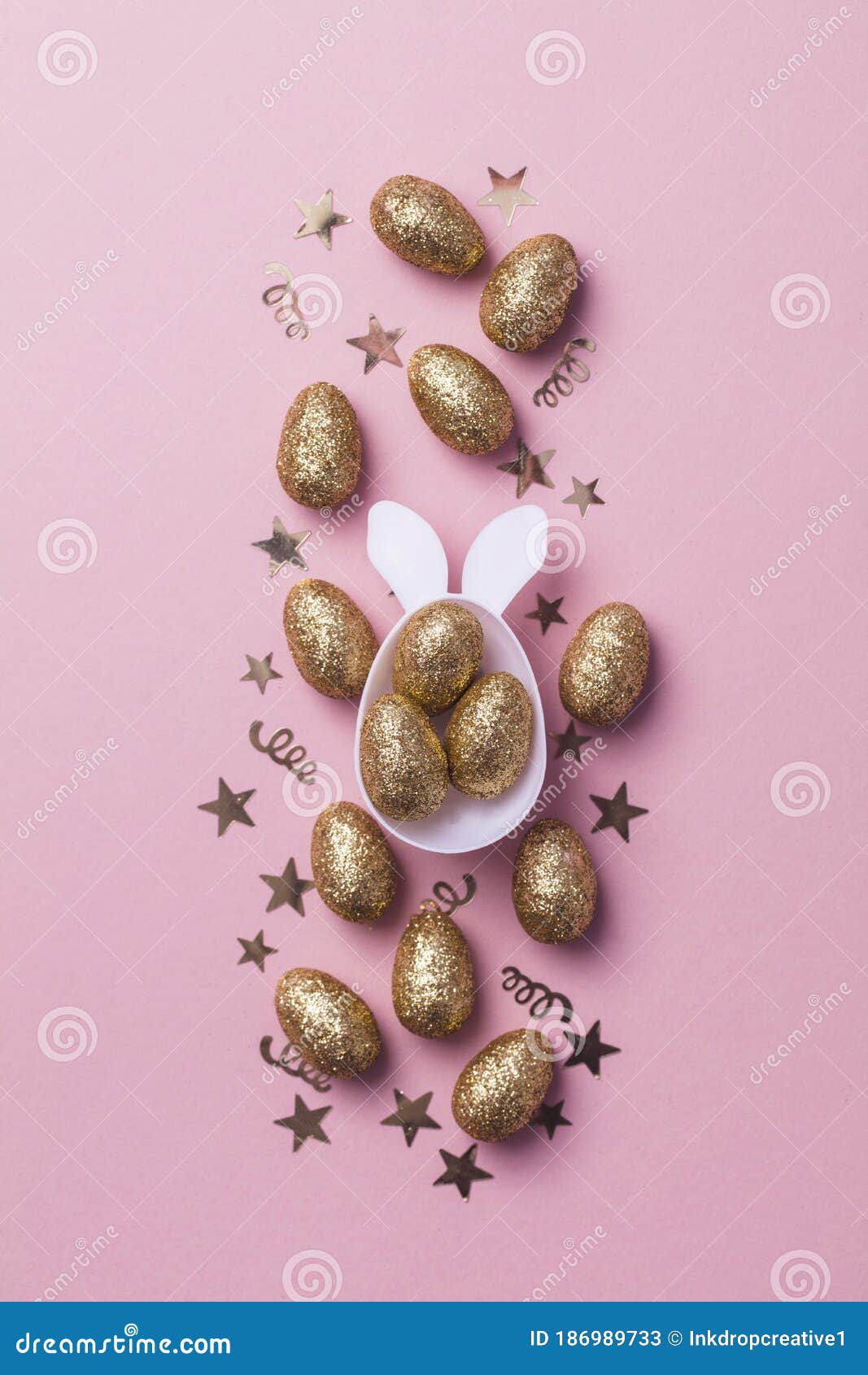 Gold Glitter Eggs in a White Easter Bunny Egg Shape with Ears Stock
