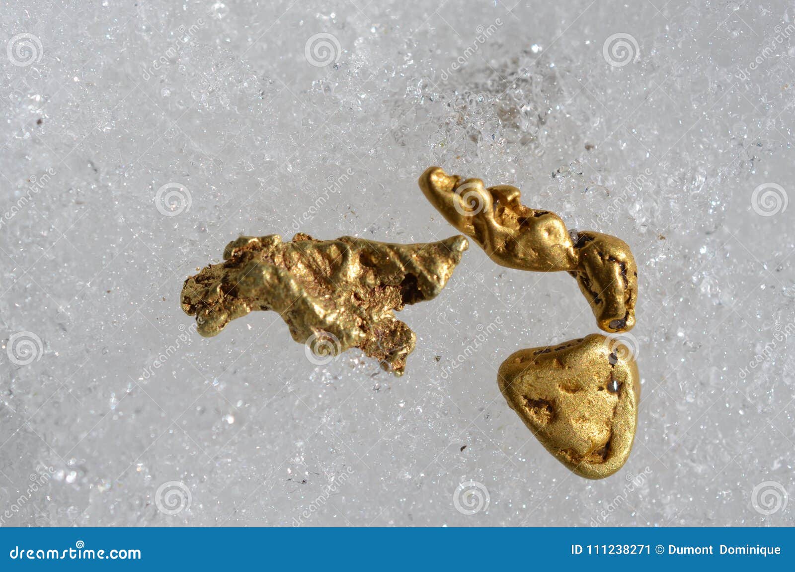 Gold Nuggets on Snow Taken Outdoors. Stock Image - Image of yellow