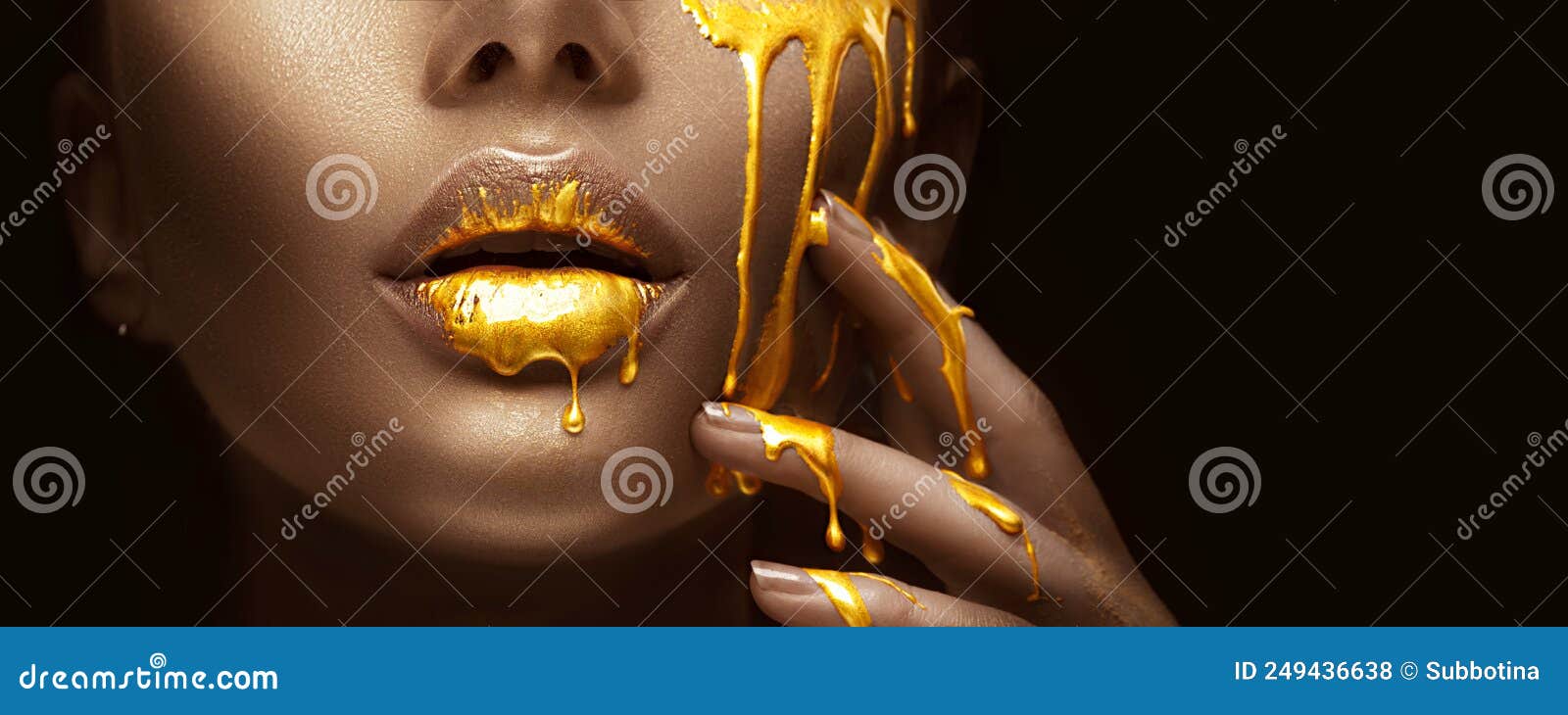 gold paint smudges drips from the face lips and nails, lipgloss dripping from sexy lips, golden liquid drops on beautiful model gi