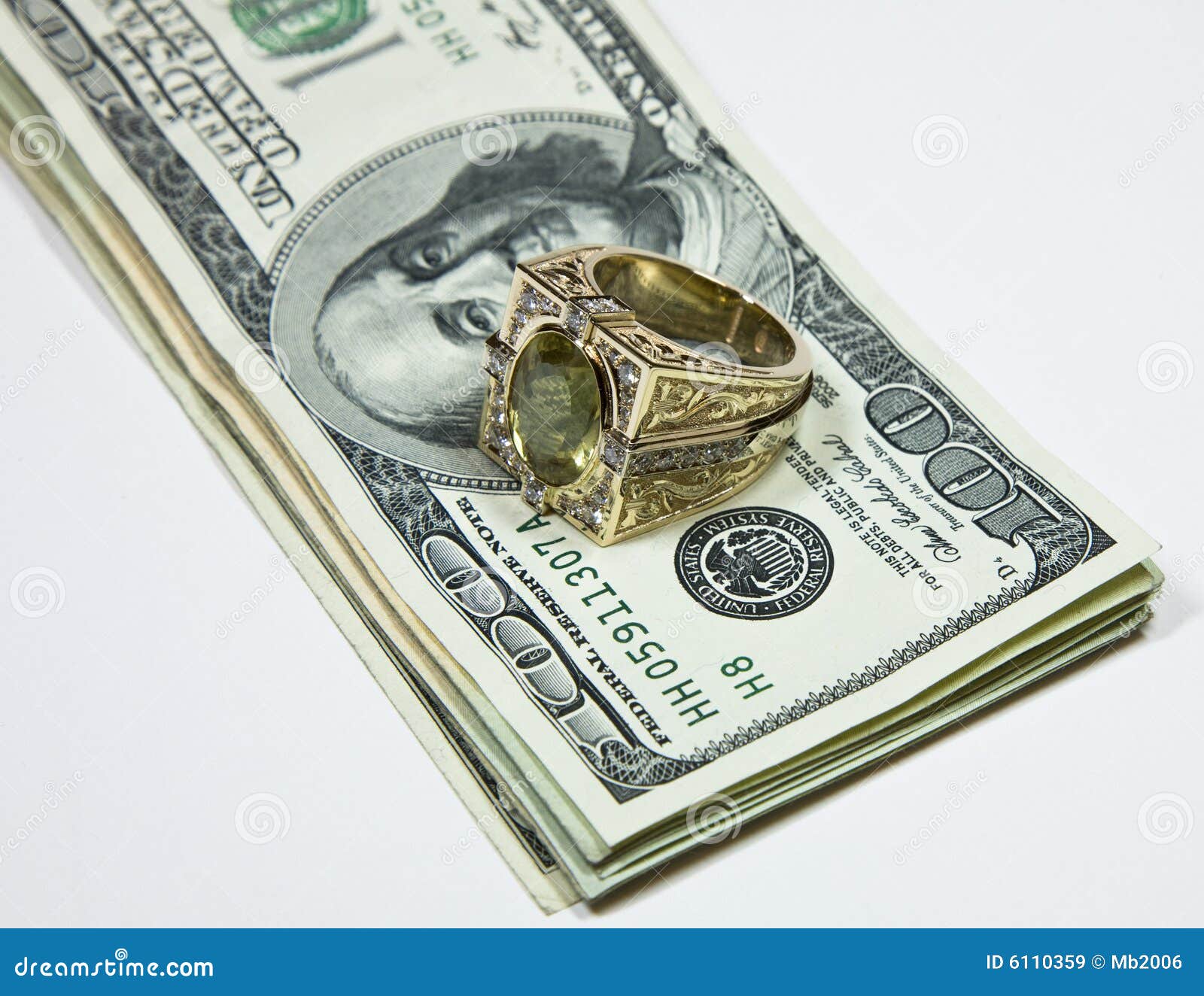 Gold ring on dollar bills stock image. Image of golden 6110359