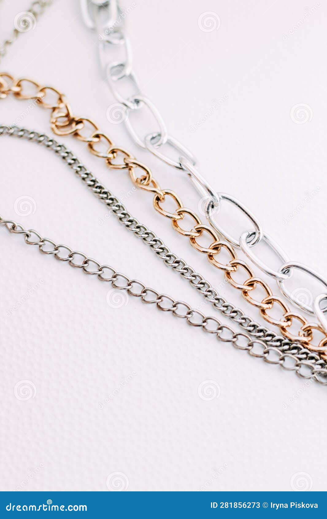 Gold and Silver Jewelry Chains of Different Diameters on a White