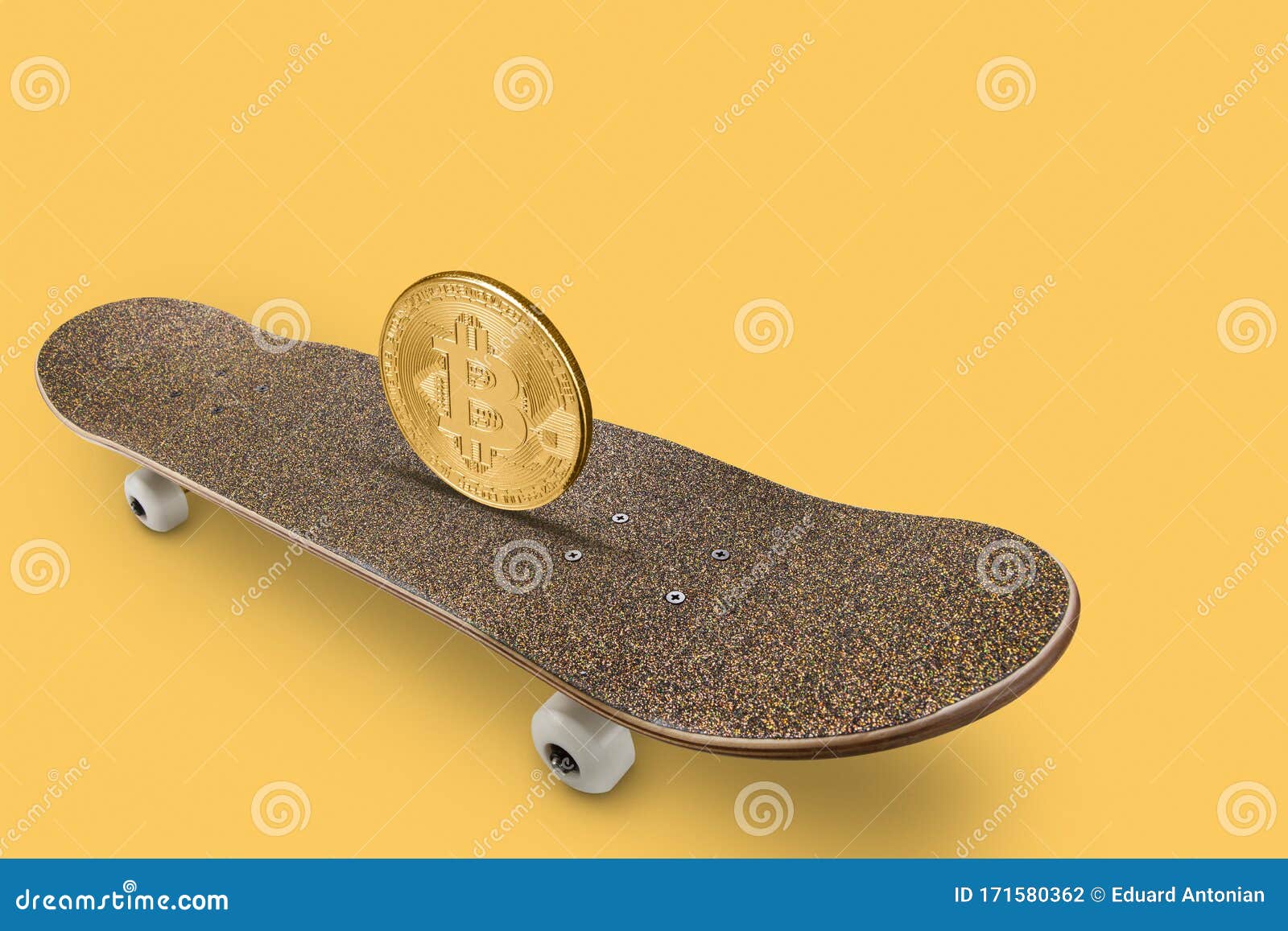 On a Gold Skateboard is on the Edge of a Big Gold Coin Bitcoin, on a ...