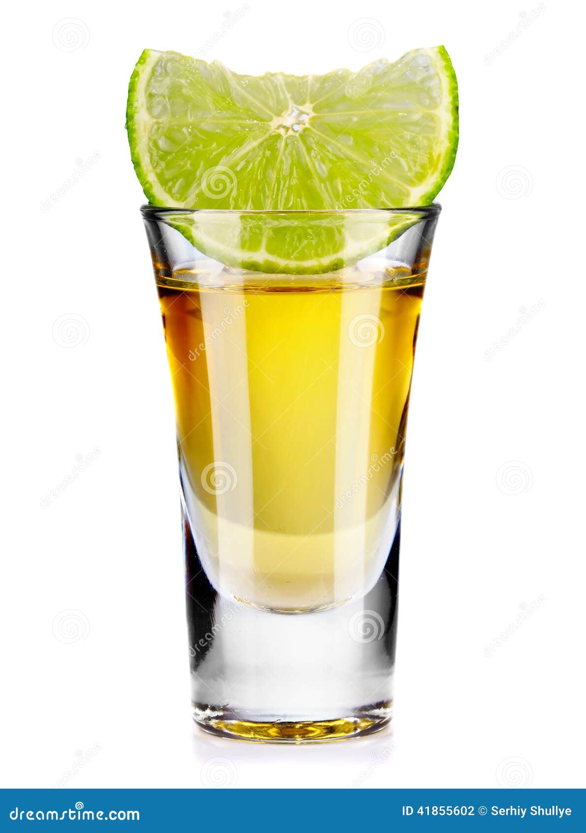 gold tequila shot with lime  on white
