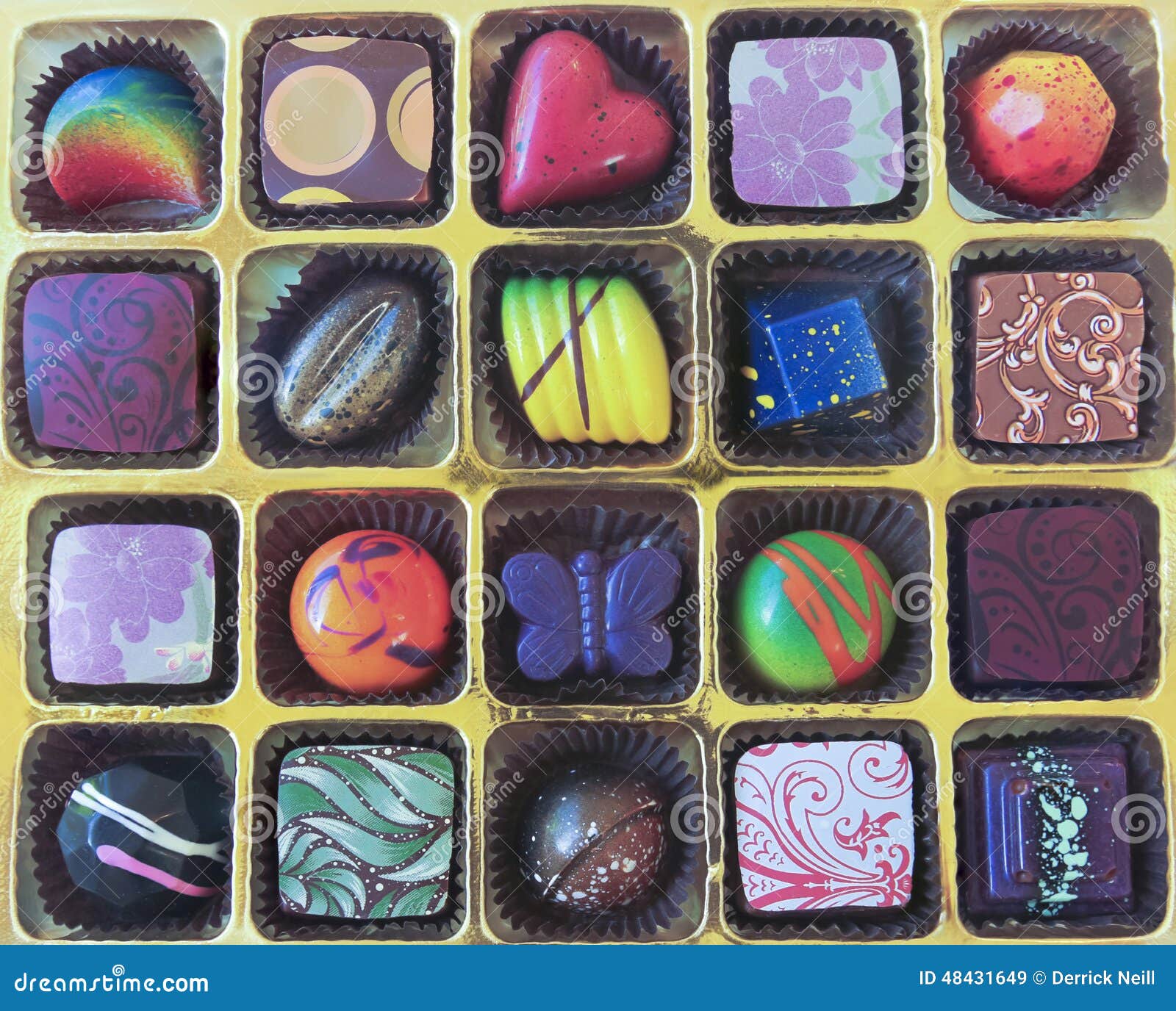 a gold tray of hand crafted chocolates
