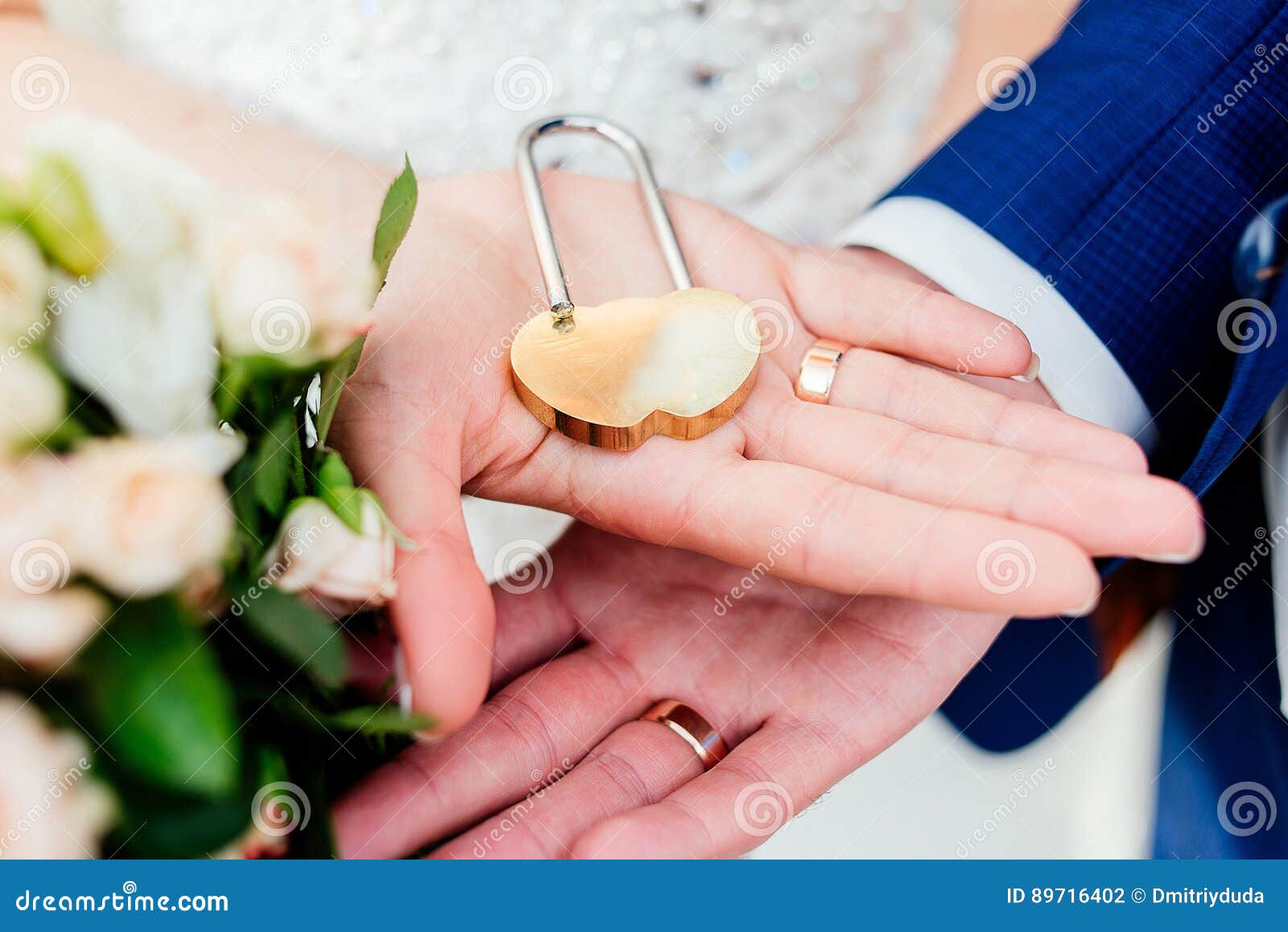 Gold Wedding Lock in the Form of Heart in the Hands Stock Photo Image