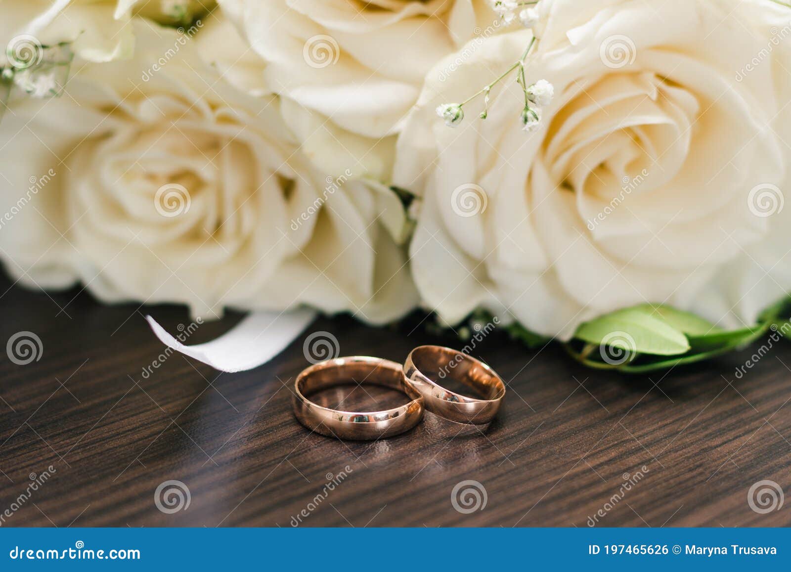 Gold Wedding Rings on a Wooden Table Against the Background of the ...