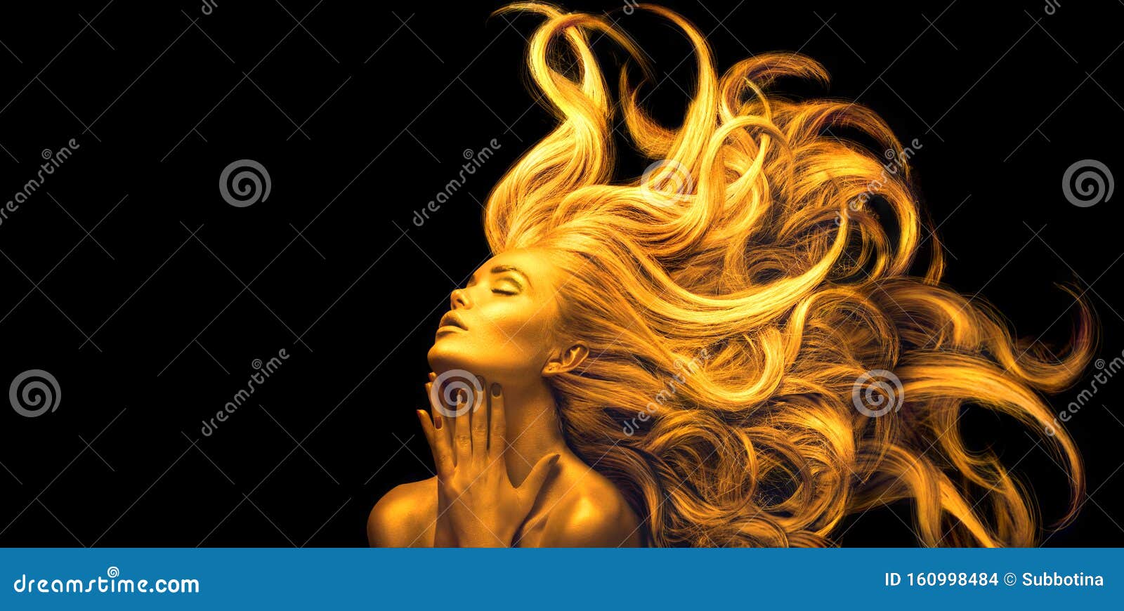 gold woman. beauty fashion model girl with golden make up, long hair on black background. gold glowing skin and fluttering hair