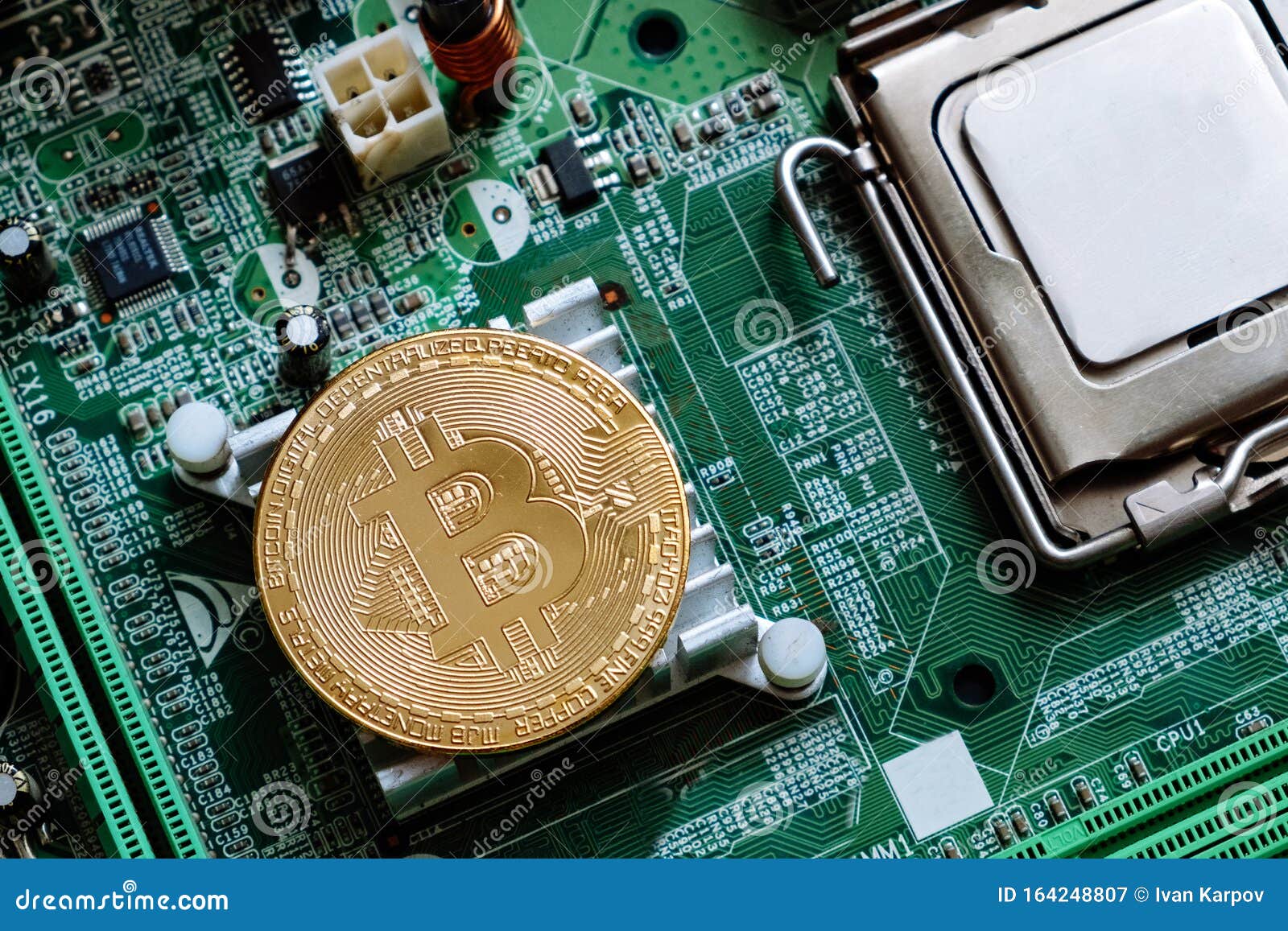 golden bitcoin on computer motheboard flat lay