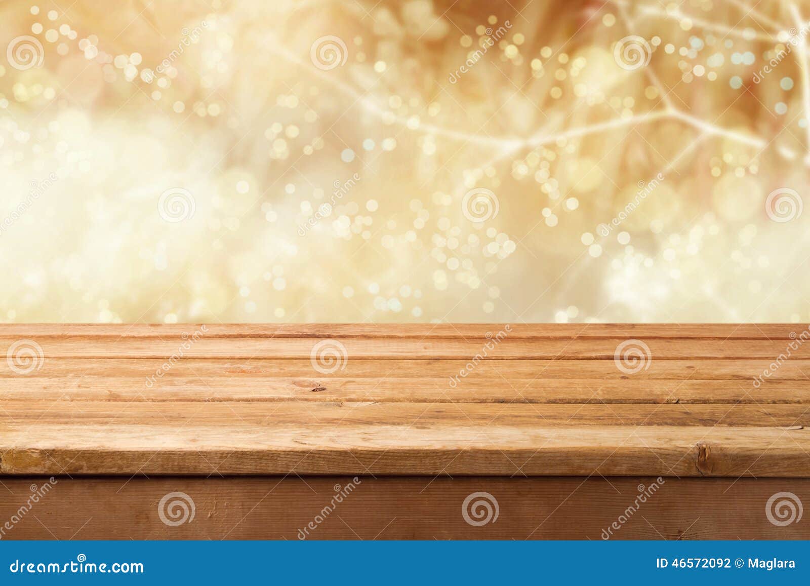golden bokeh background with empty wooden table for product montage display