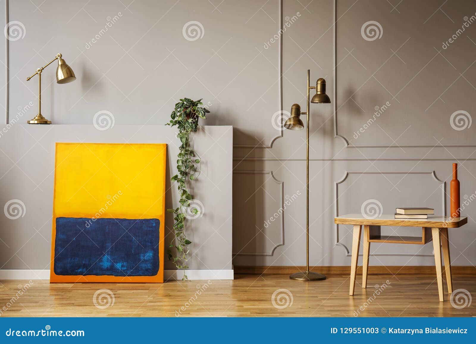 Golden Brass Floor Lamp An Abstract Painting And A Wooden Desk In