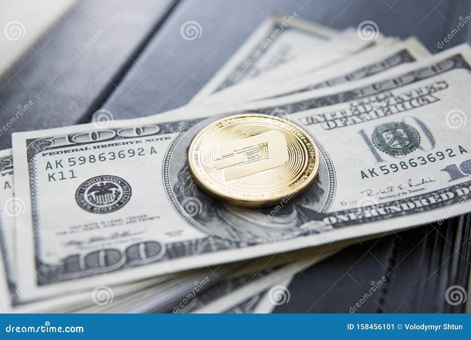 Golden Dash Cryptocurrency Coin On A Pile Of US Dollars ...