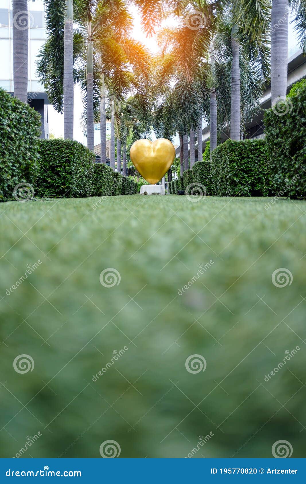 golden heart d sculpture in green garden with sunlight effect at cdc, crystal  center