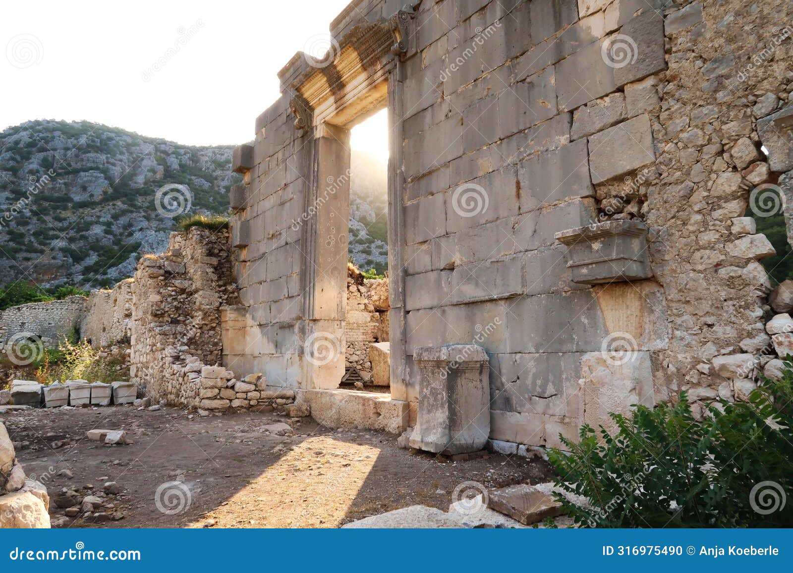 golden hour at the giant sella, cella door, entrance to ionic temple at the ancient site of olympos, olympus, built in the name of